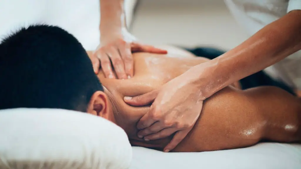 Man receiving a back massage during a wellness treatment